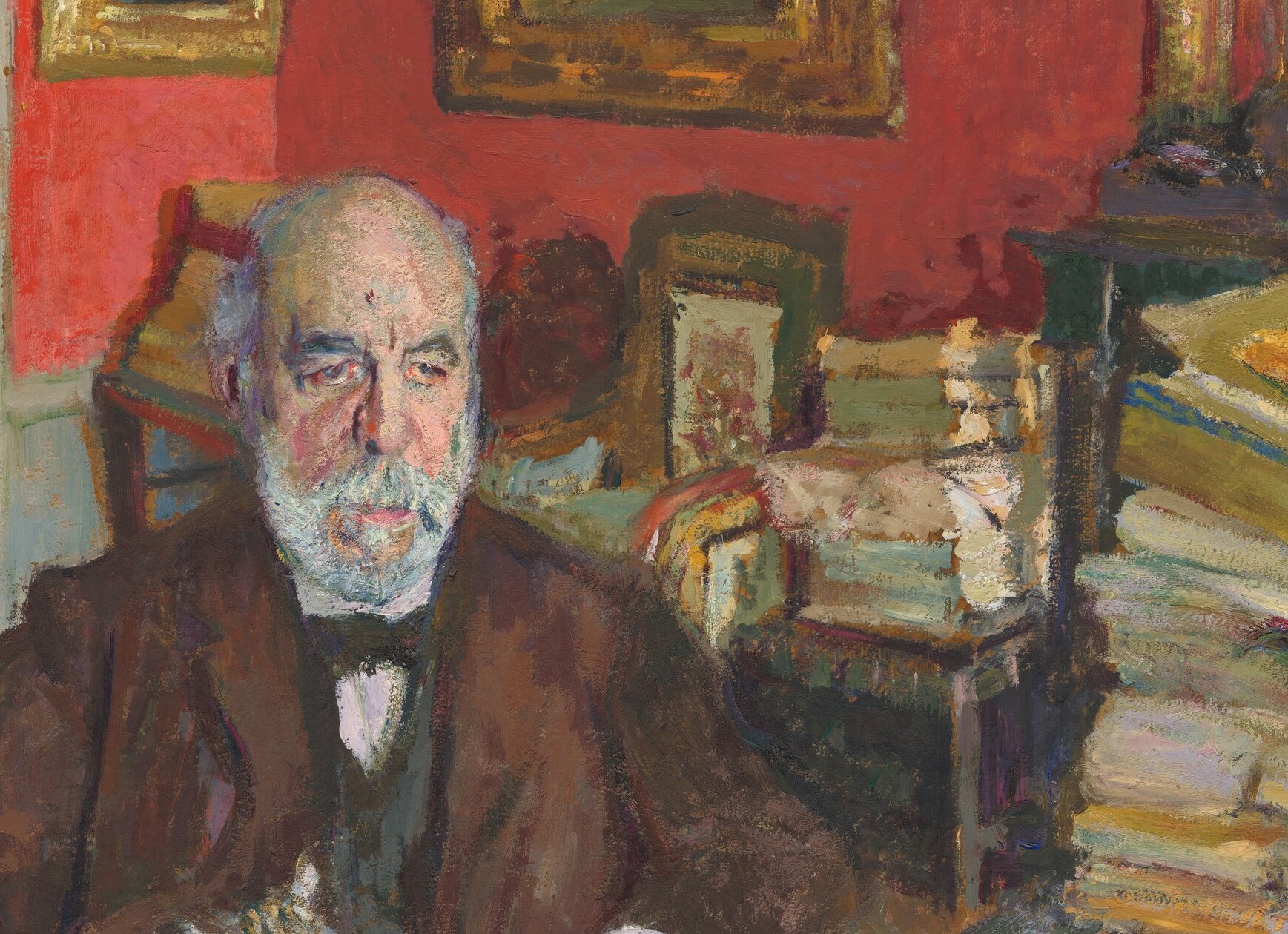 The stark contrast of dark wool against the vermillion wall is a key tonal device Vuillard uses to isolate the sitter.