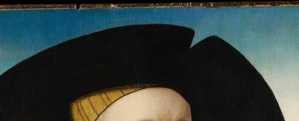 He wears the uniform of a wealthy 16th-century merchant.