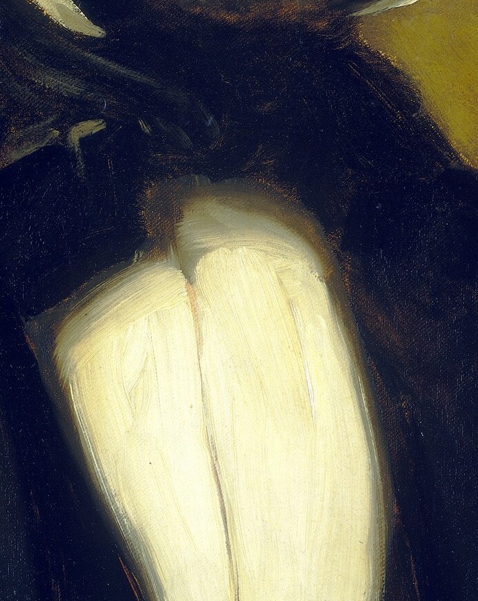 The bright white of the bow tie is a striking contrast to his dark suit, drawing the eye.