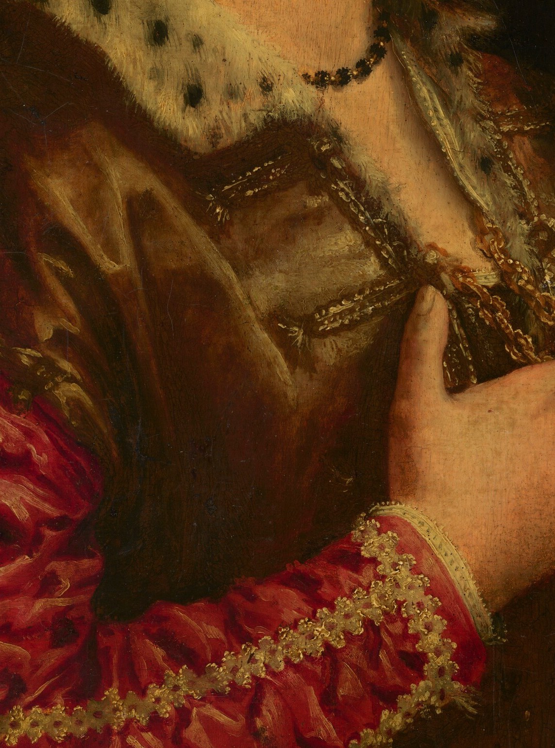 She wears a rich brown silk bodice and an elaborate lace collar.