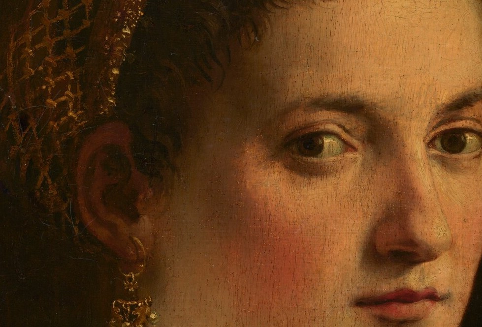 Her steady eyes are the only clue to her identity.