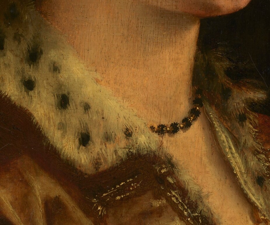 The brightest passage in the painting, drawing the eye from the face downward; the fine lace texture, if the reproduction holds, encodes the sitter's access to expensive goods.
