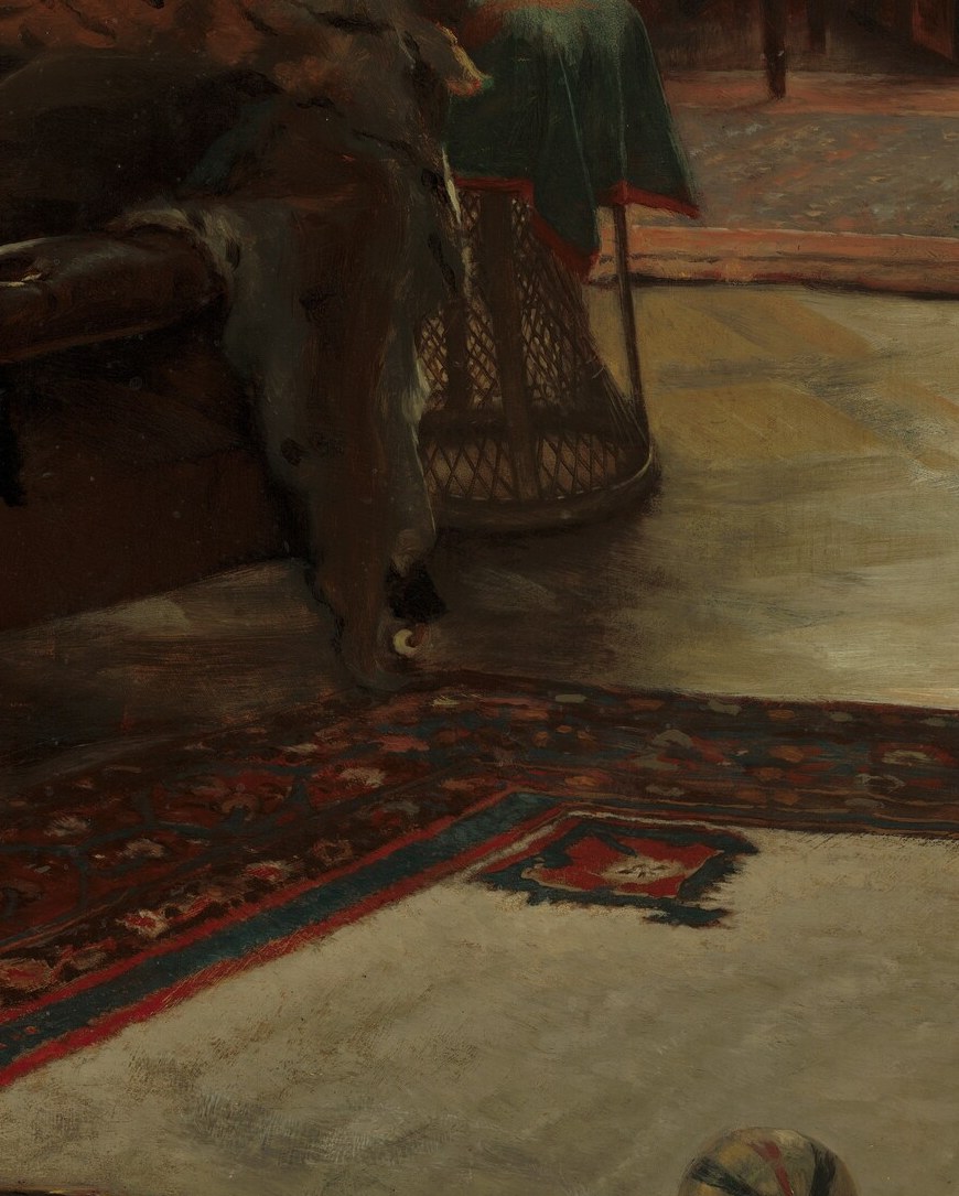 A girl in a red ribbon crawls, mid-play.