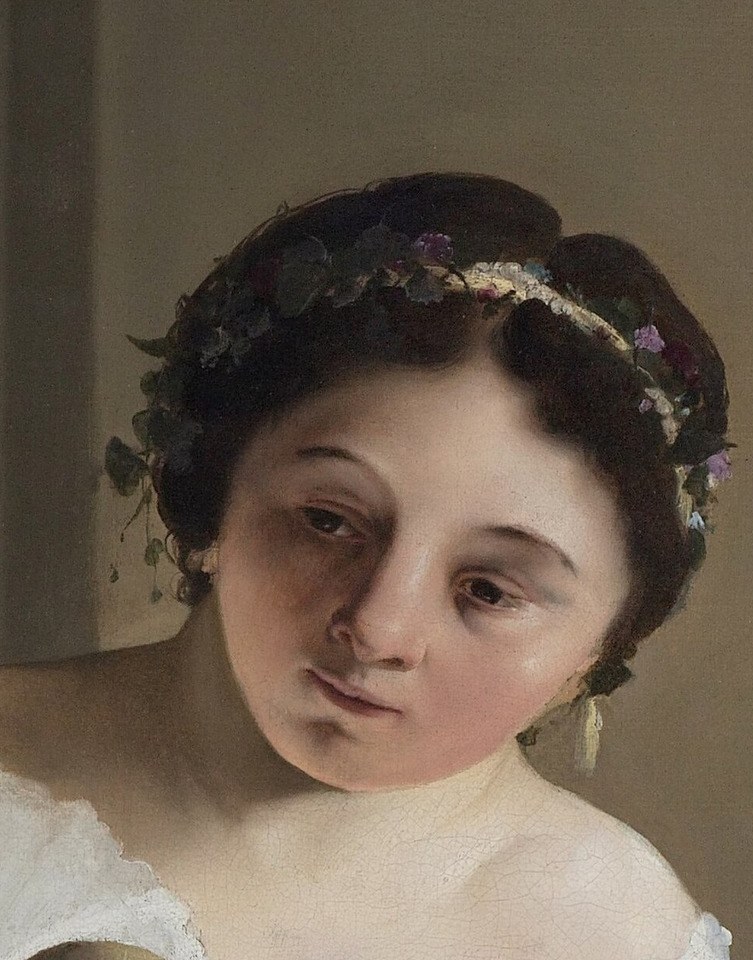 Her gaze is downcast, her posture introspective.