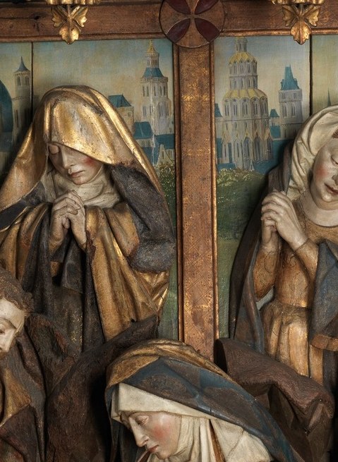 But these figures are carved wood. They step forward in real depth.