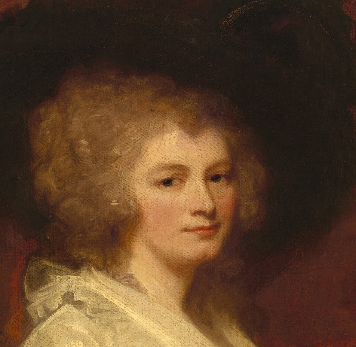 Her large hat frames a serene, poised expression.