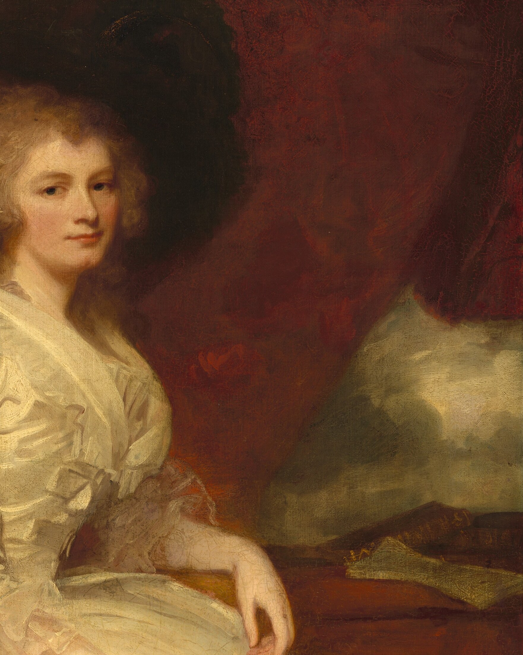 The deep red provides a dramatic contrast to her white dress and adds a sense of opulence.