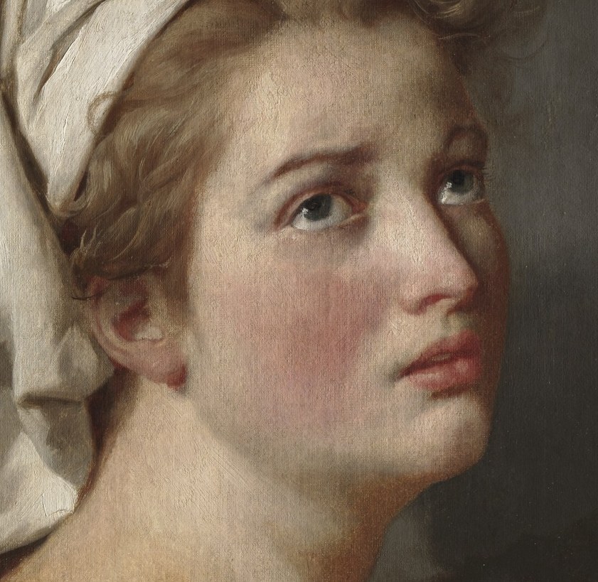 Her gaze is directed upward, as if lost in thought.