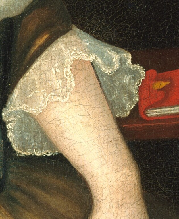 The intricate lace on her cuffs shows her refinement and status.