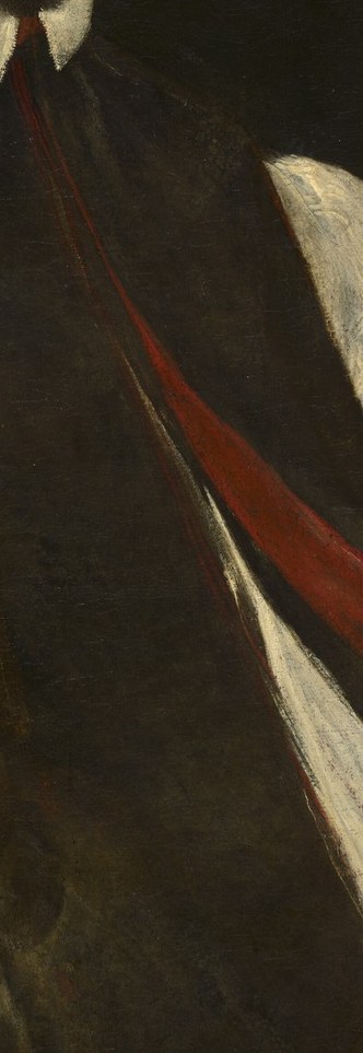Look closer at the red sash.