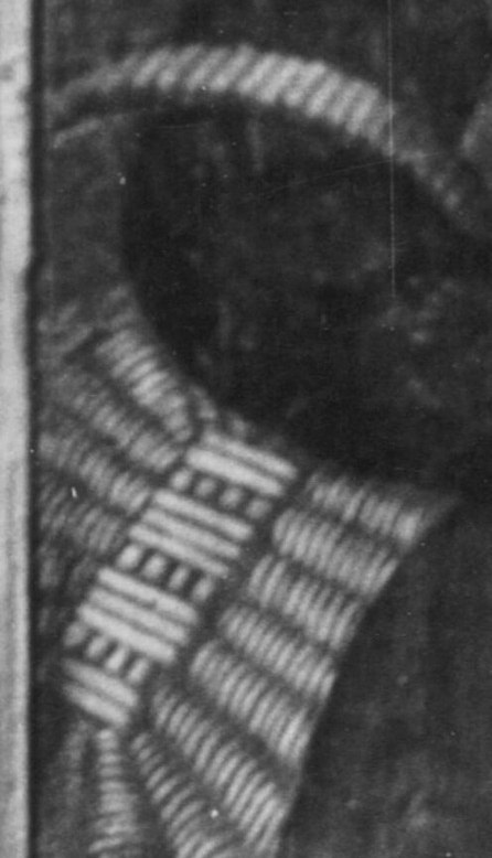 But look closely at the fabric behind her shoulder.