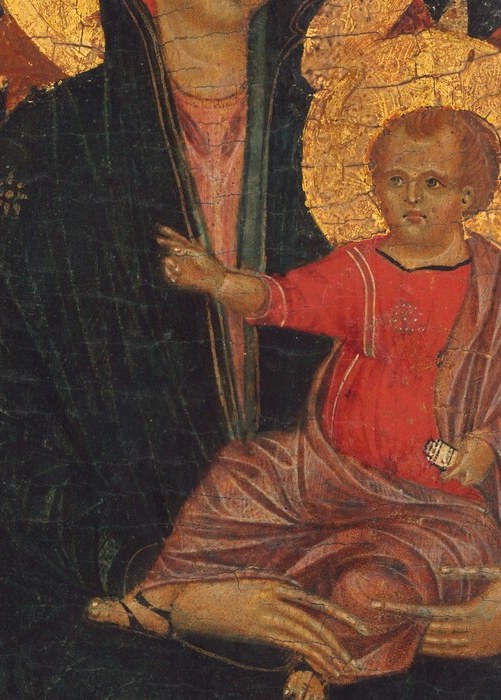 The Child blesses with his right hand and holds a scroll in his left , both gestures packed into a tiny form, condensing the theological program of the whole panel
