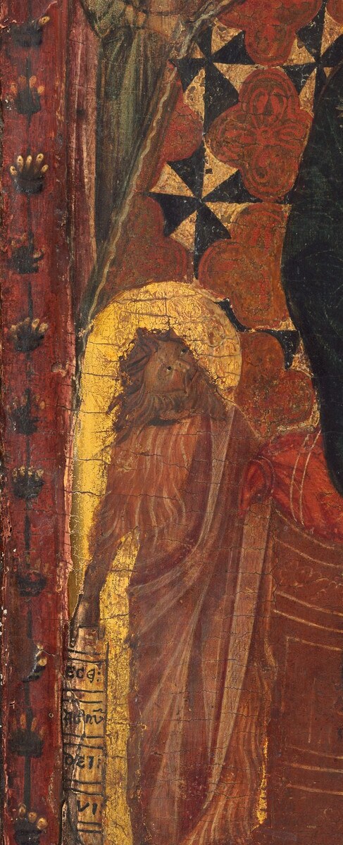 John holds a scroll inscribed 'ECCE AGNUS DEI' , a legible text that gives the viewer something to decode and anchors the panel in liturgical time
