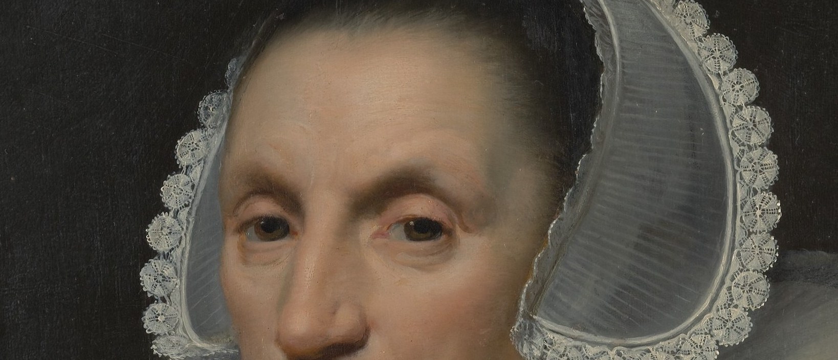 A woman, severe and self-possessed, looks straight at you.