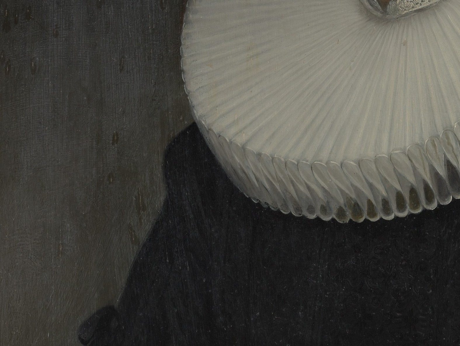 Her ruff is a showpiece of white-on-white painting, dozens of individually lit folds.