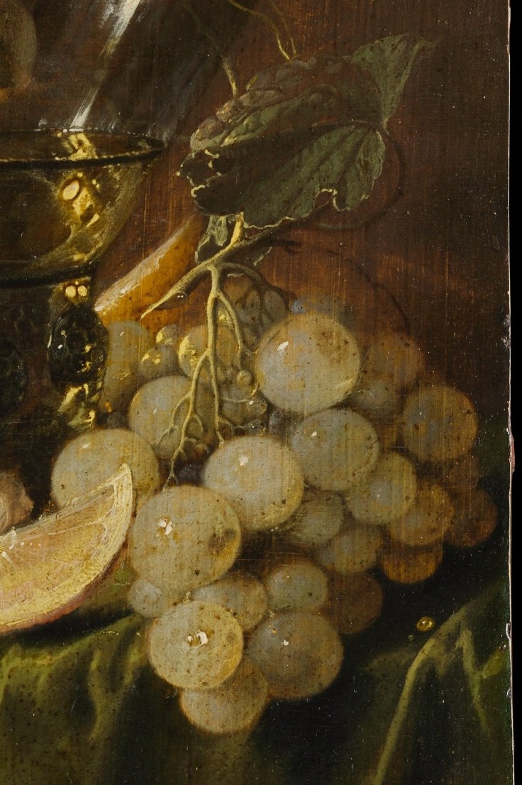 Each grape reads as an individual translucent sphere; the skin thins visibly where light passes through. Grapes link to wine, to the Eucharist, and to the abundance that the whole table celebrates.