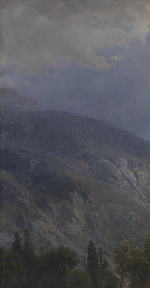Deep shadow keeps this wall almost featureless , the darkness frames the central light and emphasizes the valley's enclosed, cathedral quality.