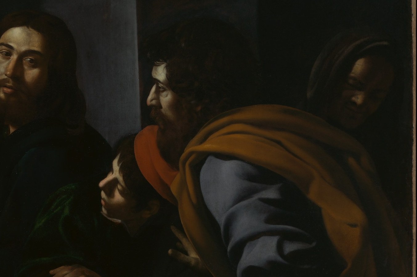 The dramatic light, called chiaroscuro, creates intense focus.