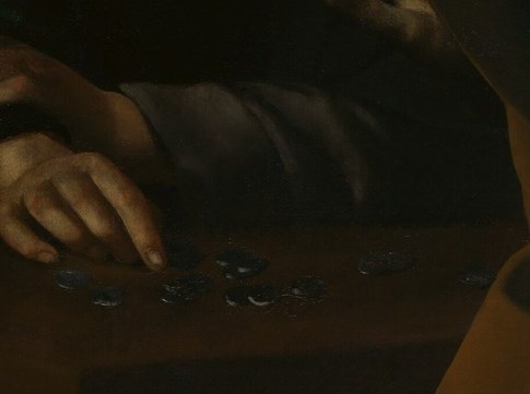 His hands are still poised over the coins on the table.