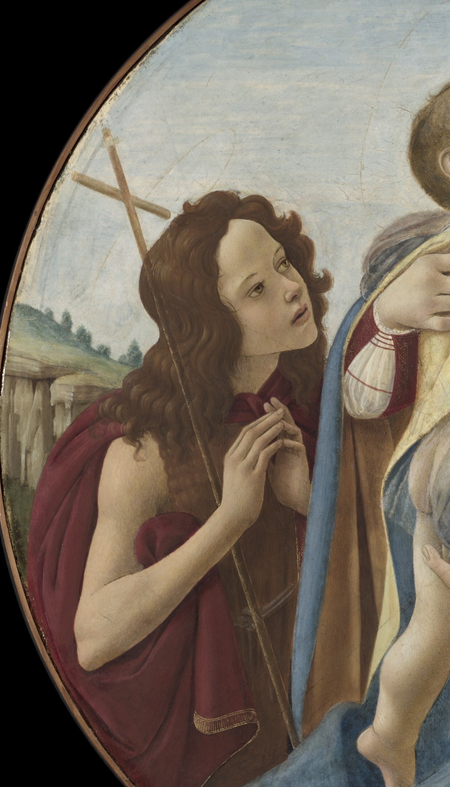 John's slightly turned, upward gaze and rough reddish garment contrast with the central softness , he already prefigures his wilderness role as witness to the Lamb.