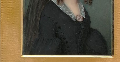 The dark, voluminous fabric of her dress provides a strong contrast to her face and collar, emphasizing her presence.