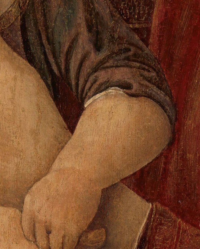 His small hand rests on her arm, a gesture of trust.
