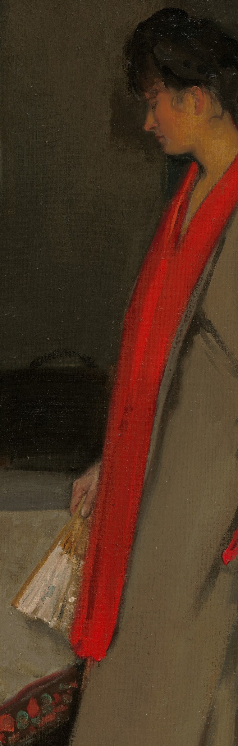 Her red sash and slippers add a flash of vibrant color.