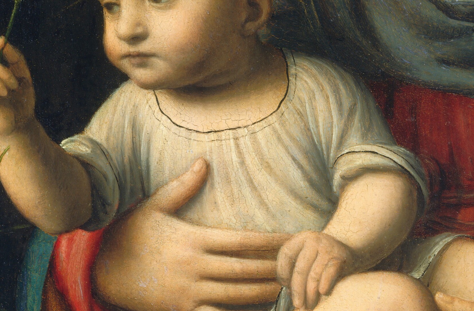 Mary gently cradles the Christ Child, a tender, human moment.