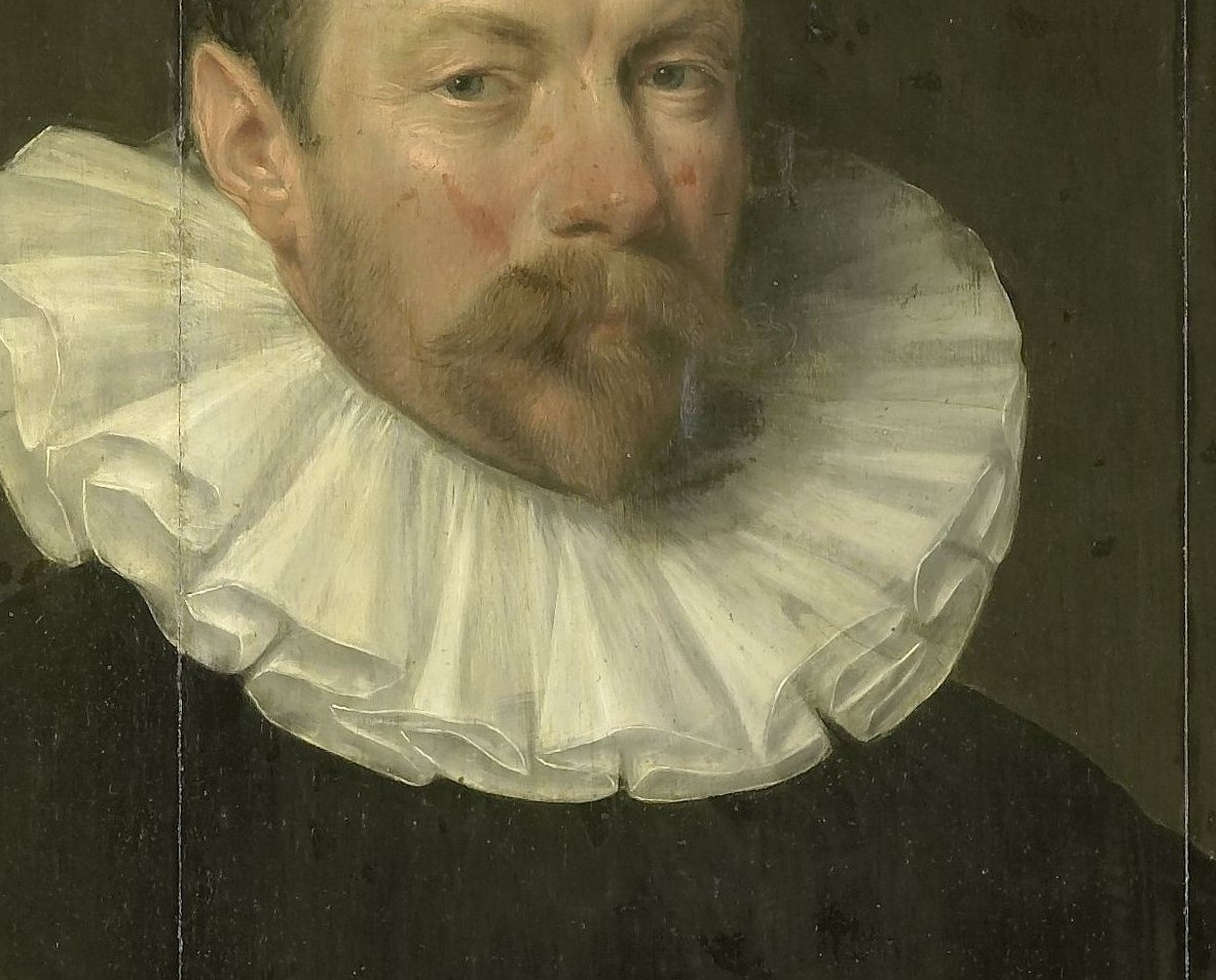 The stiff ruff collar signifies his wealth and status.