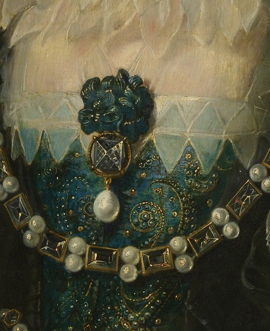She wears the finest fabrics, lace, and jewels of her era.