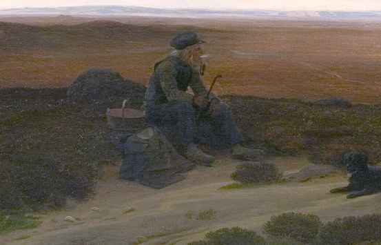 A man sits on a rocky outcrop.