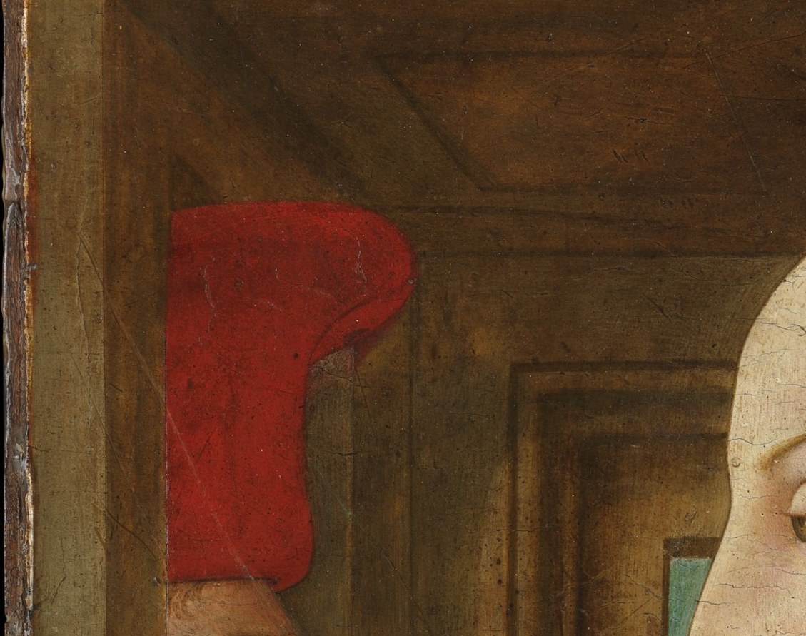 The hat's bright red echoes the woman's gown and binds the two figures chromatically; its soft Flemish-influenced form points to mid-15th-century mercantile fashion that a costume historian would date precisely.