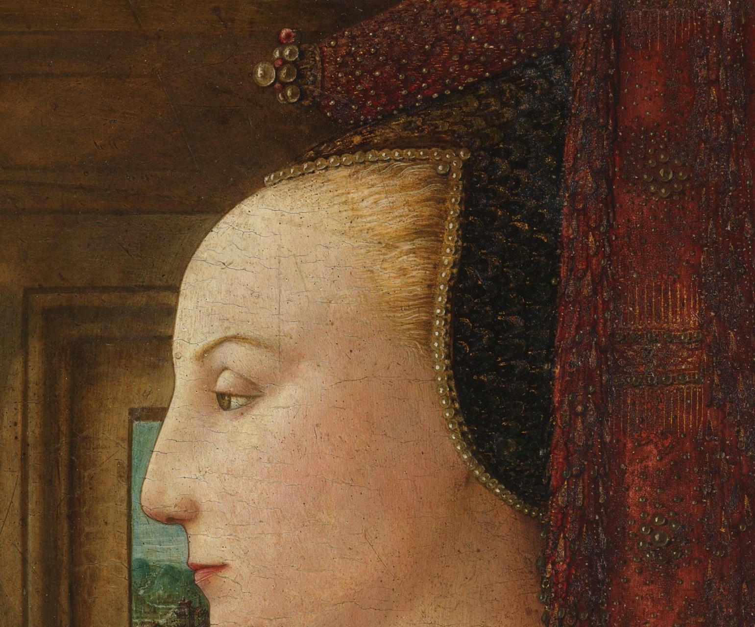 The defining image of the painting , serene, idealized, almost heraldic in its rigidity; a textbook example of the Florentine profile portrait convention that erases personality in favor of dynastic permanence.