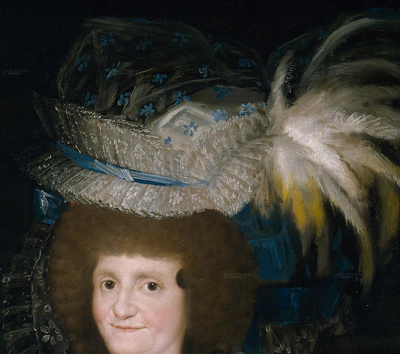 Her elaborate dress and hat show her high status.