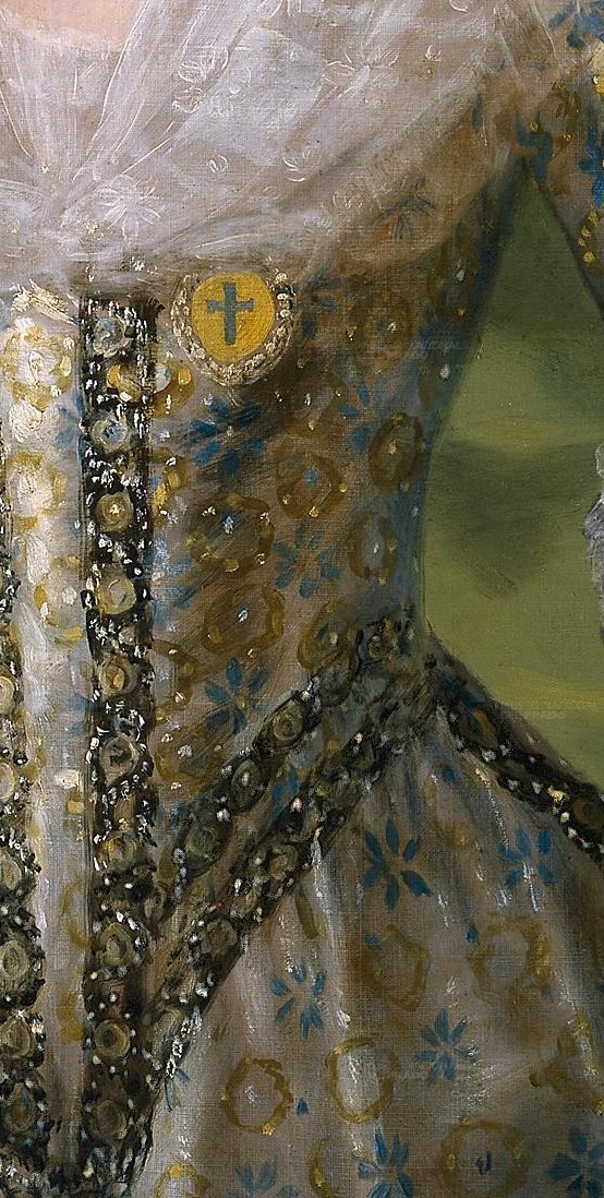 The heavily embellished corset emphasizes the queen's figure and the richness of her attire.