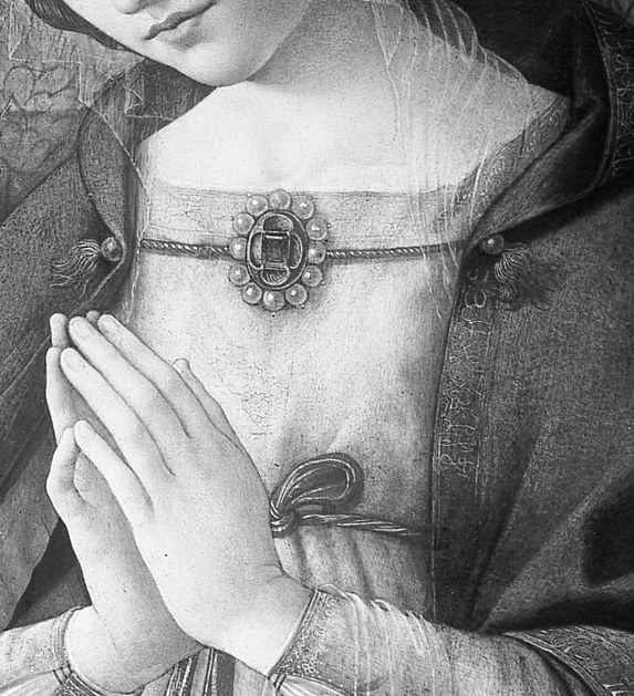 Her hands are pressed together in prayer.