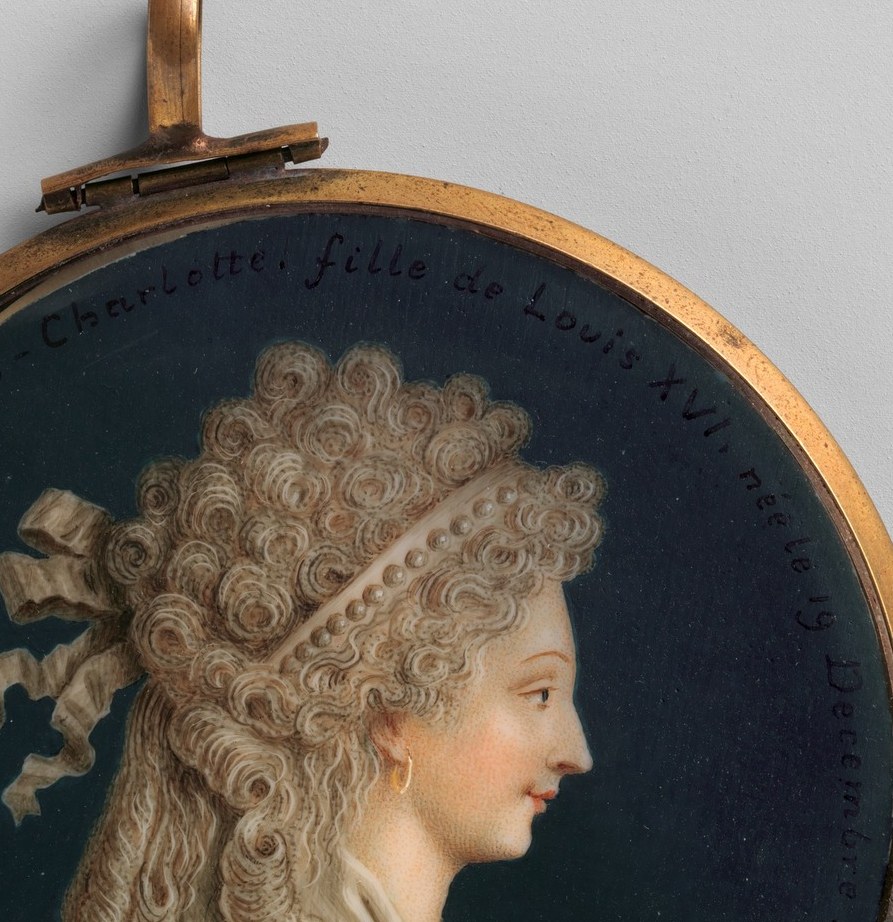 A young woman in strict profile, like a figure on an ancient coin.