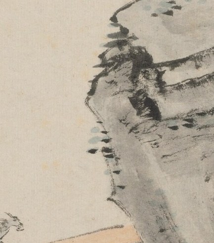 A man and his donkey, small against the rock.