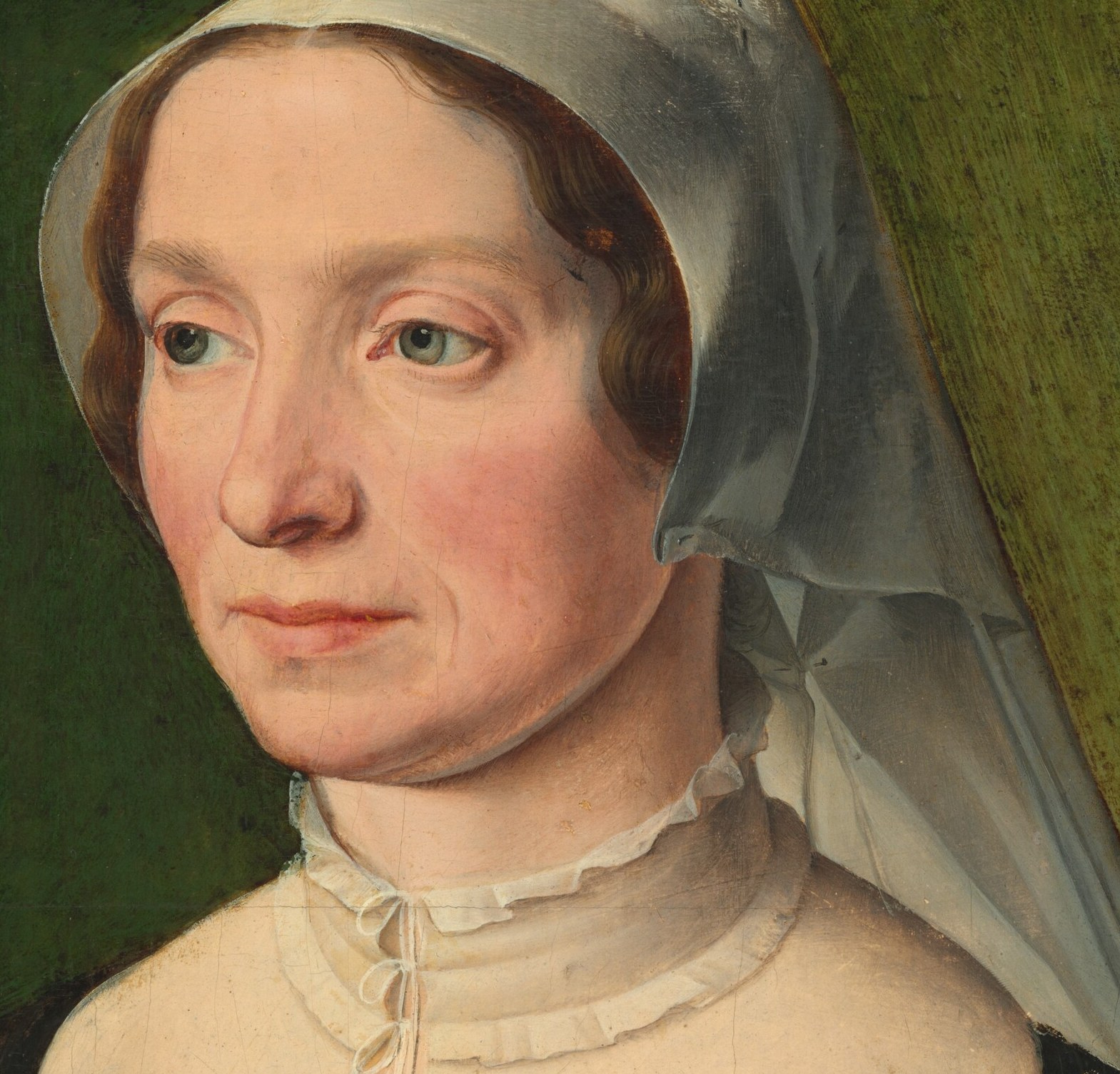 Her sheer head covering and ruffled collar were very much in style.