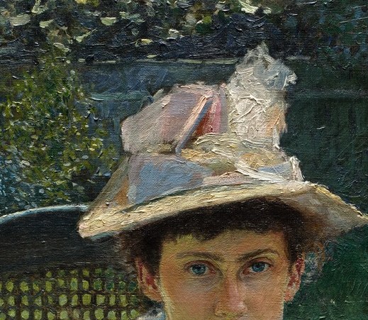 The hat, adorned with delicate feathers and ribbons, adds a touch of elegance and frames her face.