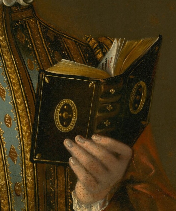 Holding a book implies literacy and intellectual pursuits, adding depth to her character.