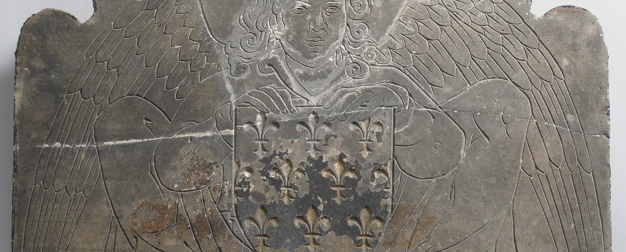 Look closely at the angel's delicate, carved wings.