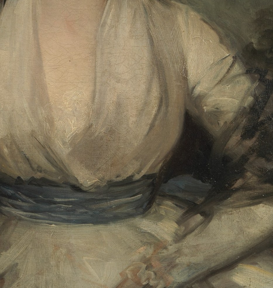 Look closely at her low-necked, pale gown.