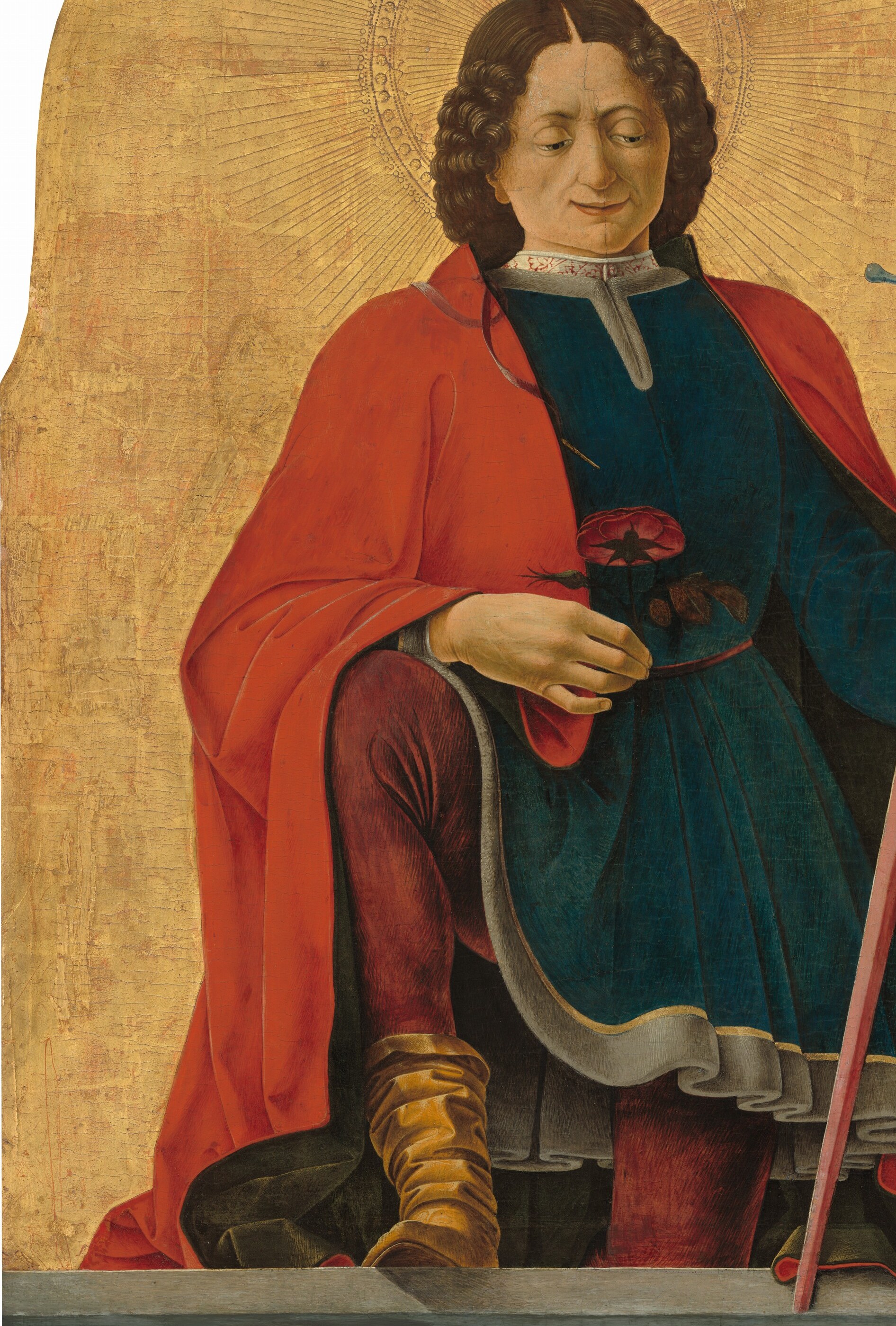 Broad planes of vermillion with deep shadow folds show Cossa's mastery of drapery volume , the cloak almost envelops the composition