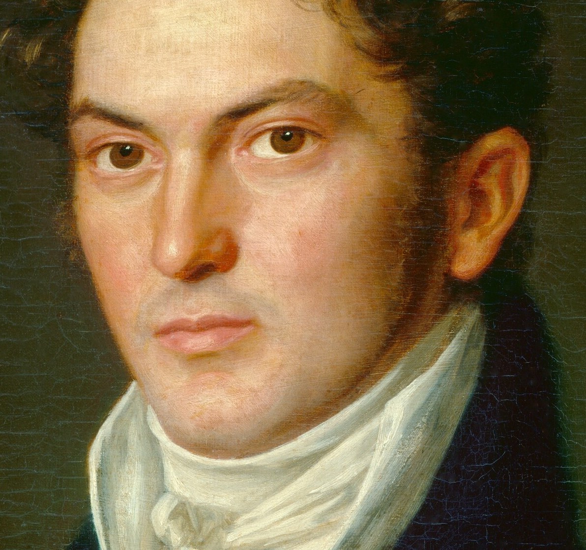 His direct gaze and subtle expression convey a sense of introspection and quiet authority.