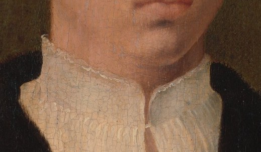 His collar is finely pleated white.