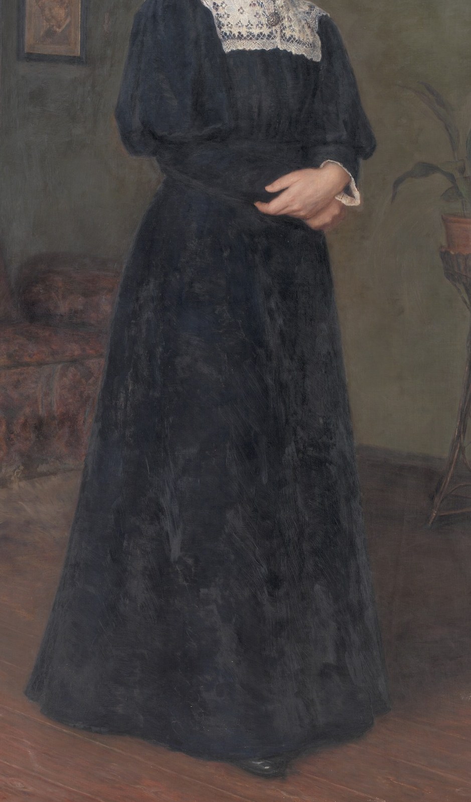 The voluminous black dress dominates the composition, its dark fabric absorbing light and emphasizing the figure's presence.