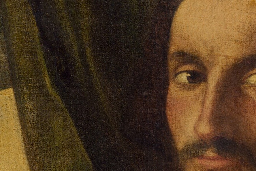 The gaze breaks the typical direct portrait convention; a close cut here conveys deliberate aloofness or distraction that invites questions about who or what he watches.
