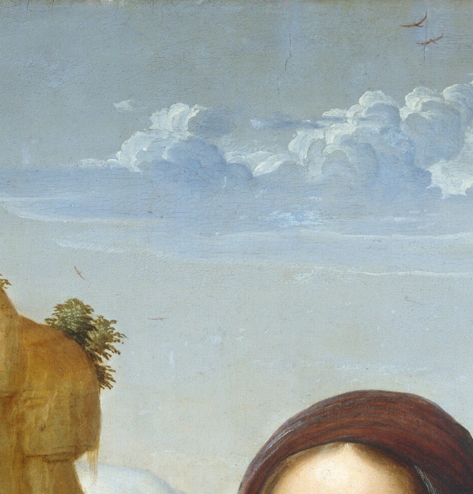 Her face emerges from shadow with no hard edges.