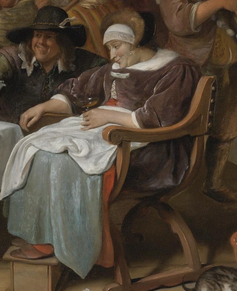She lifts her glass at the center of the celebration.